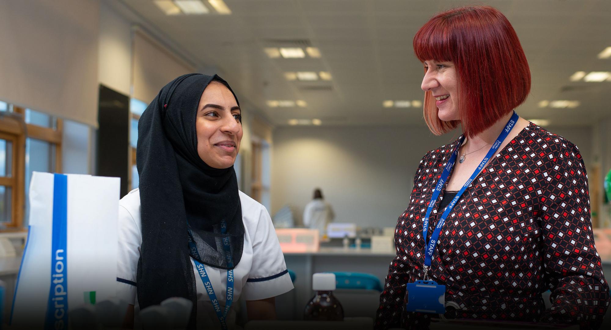Amina Zaheer, Themis Apprentice, with friendly expert Trainer Assessor in state-of-the-art Burnley College lab