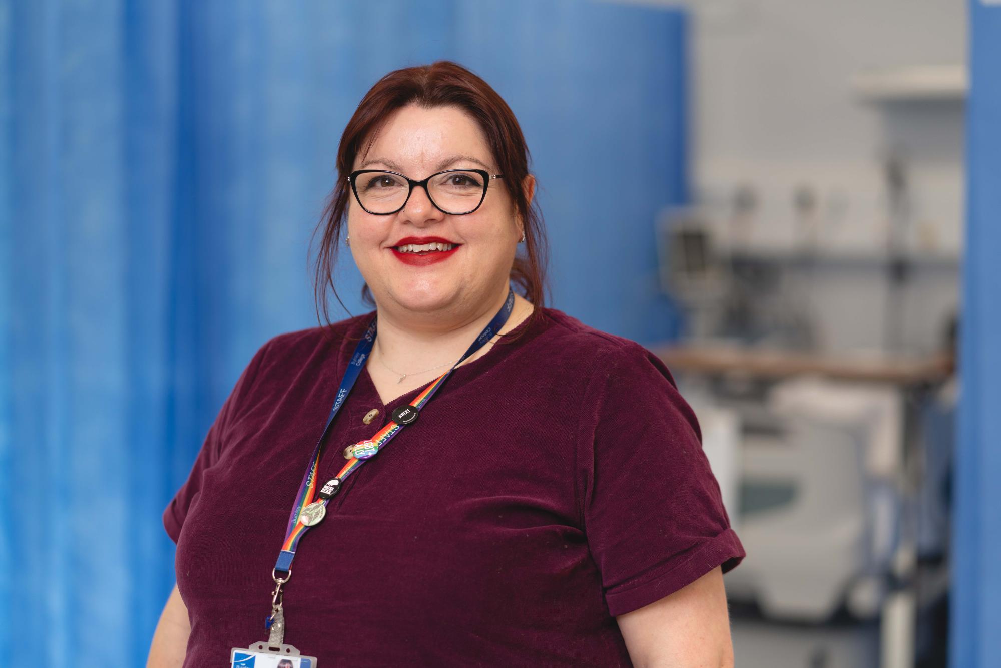 A proud tutor stands in front of her amazing sim suite at Burnley College