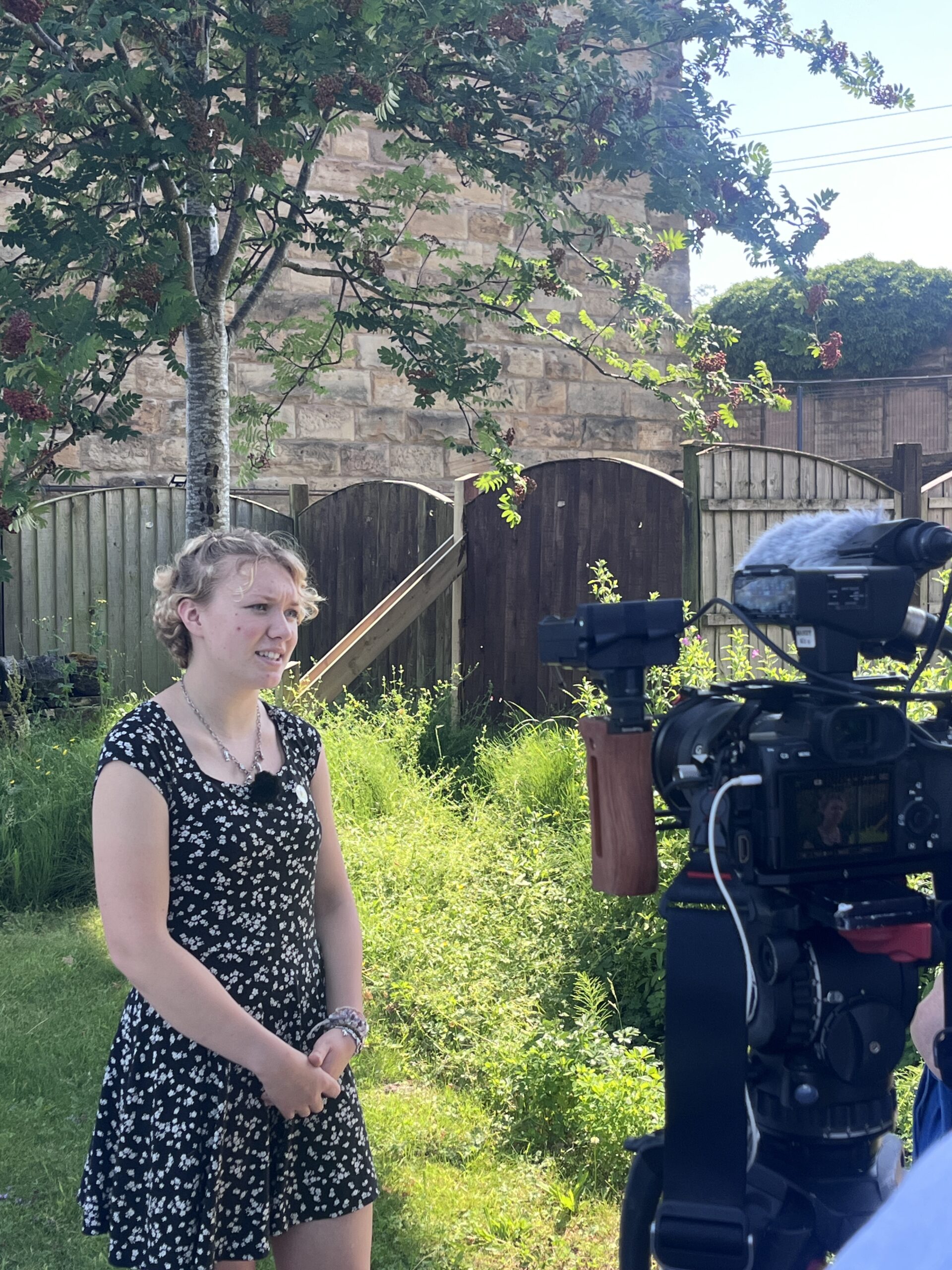 20260626_104106396_iOS A student being interviewed on camera outside