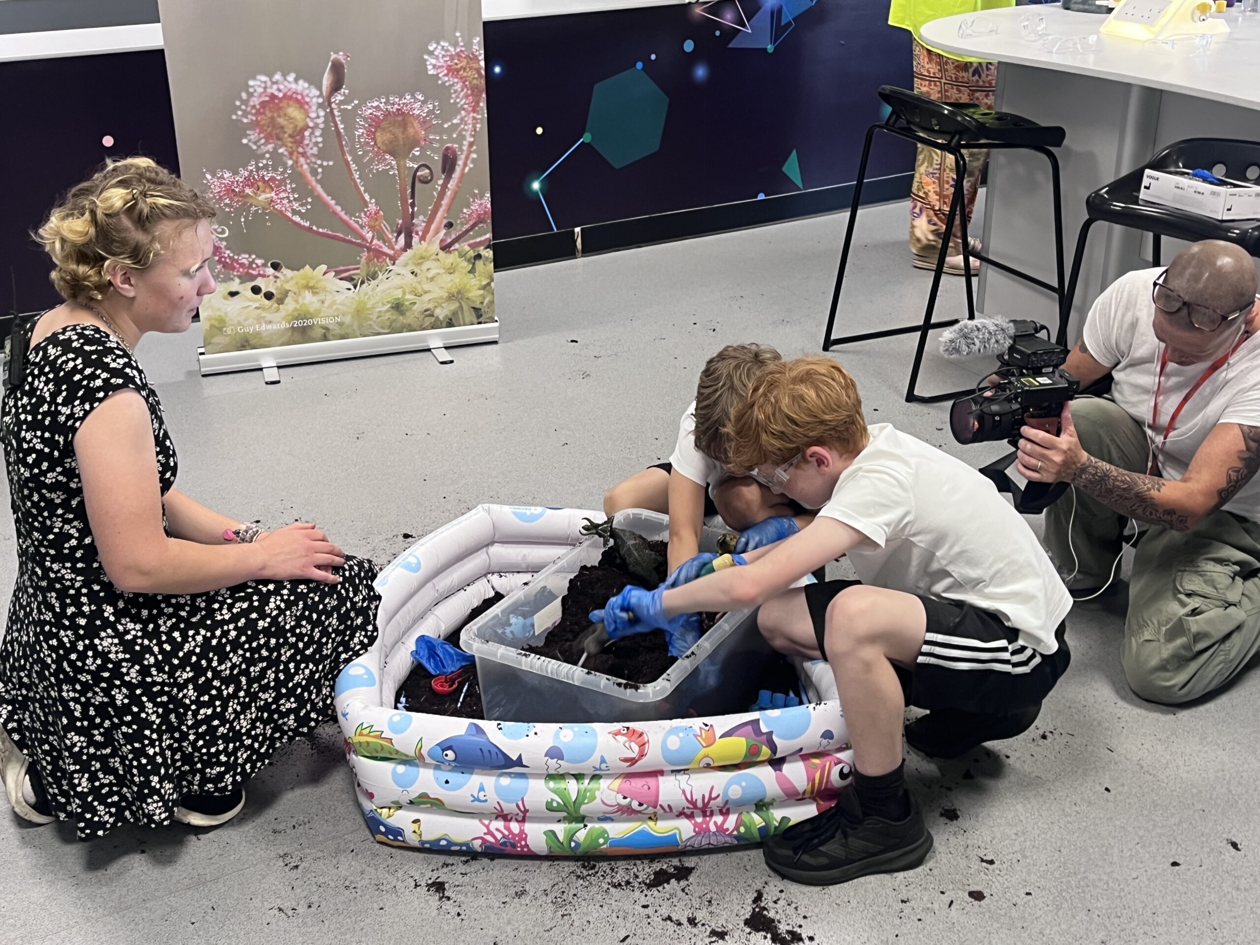 Primary pupils digging in soil in a science lab