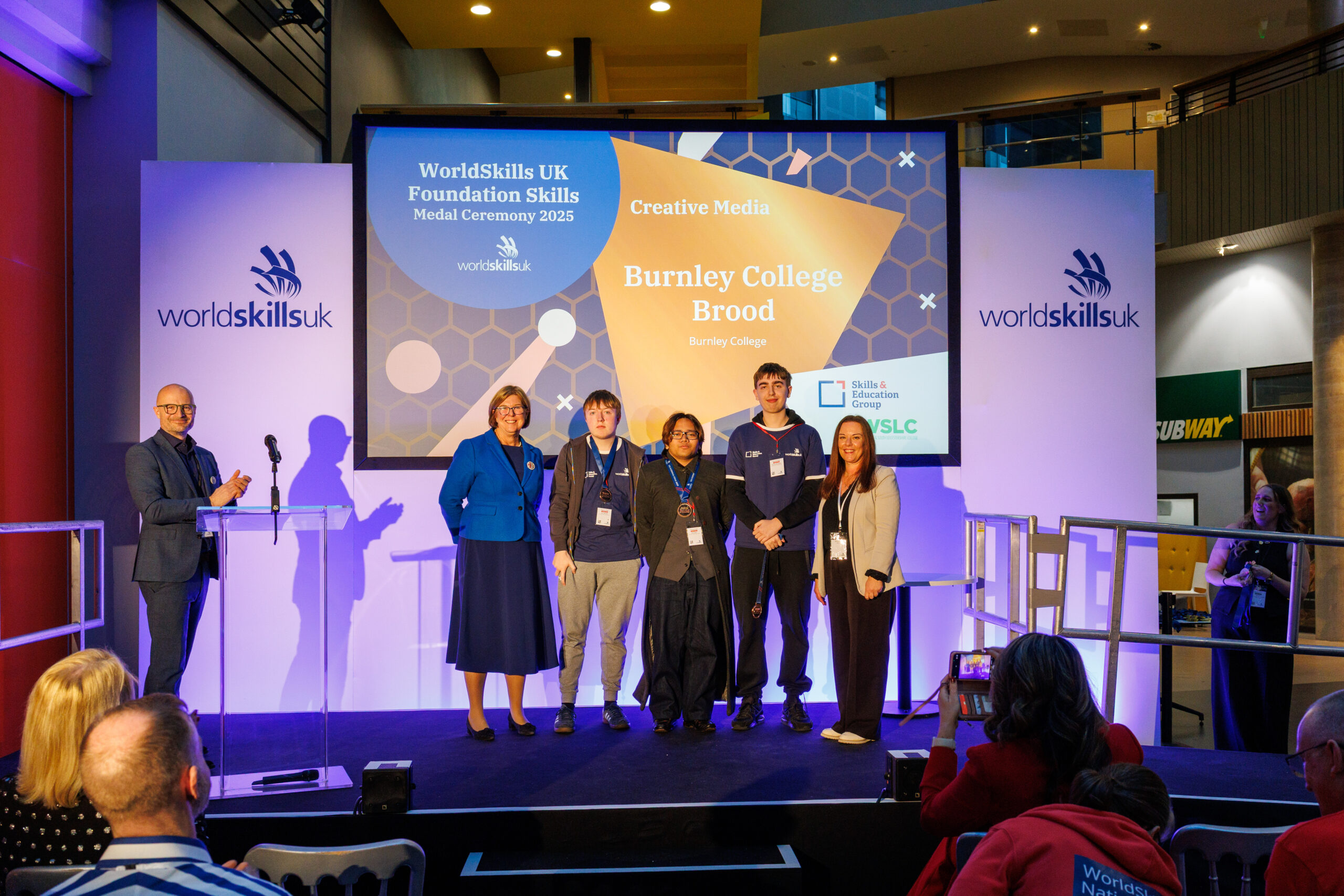 The winning Burnley College team of three learners pose with their bronze medals at a WorldSkills UK 2025 medal ceremony.
