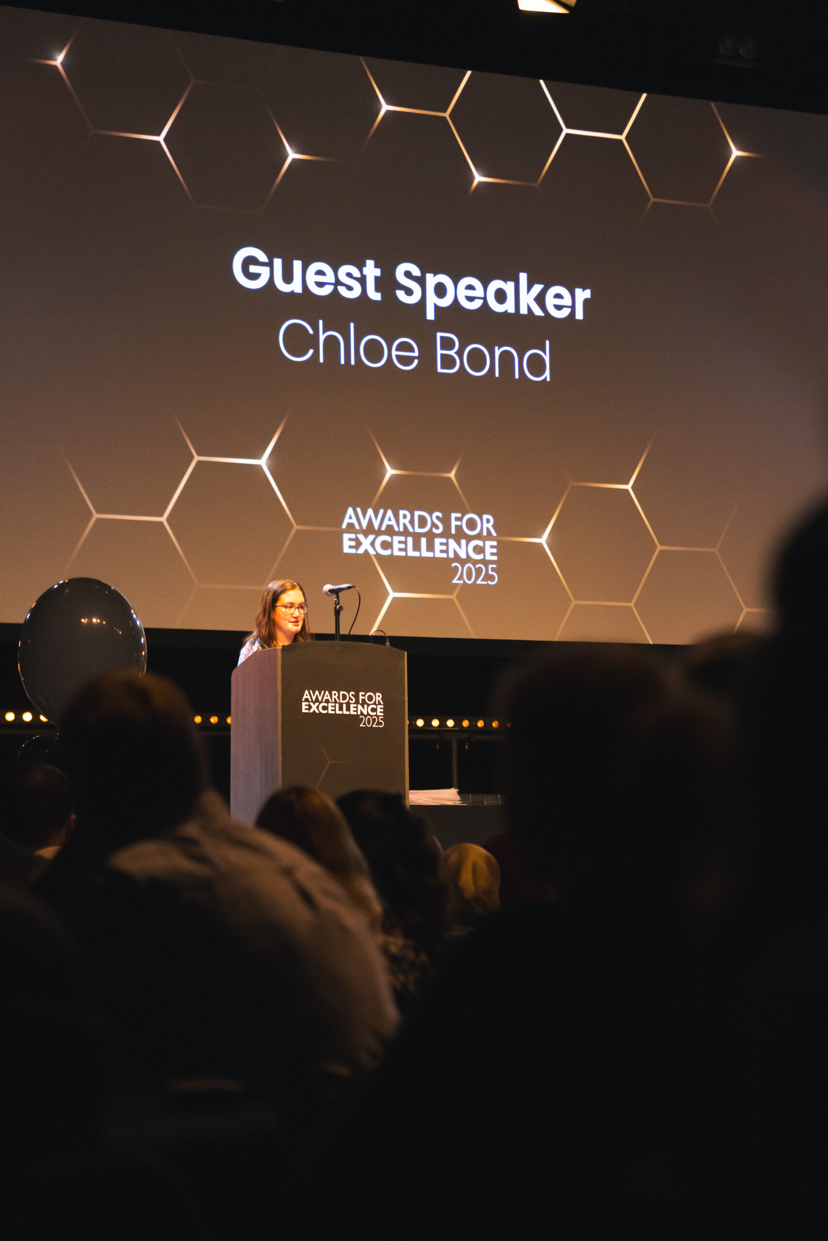 Chloe Bond Awards For Excellence Speech Chloe on a stage, reading her speech at awards for excellence
