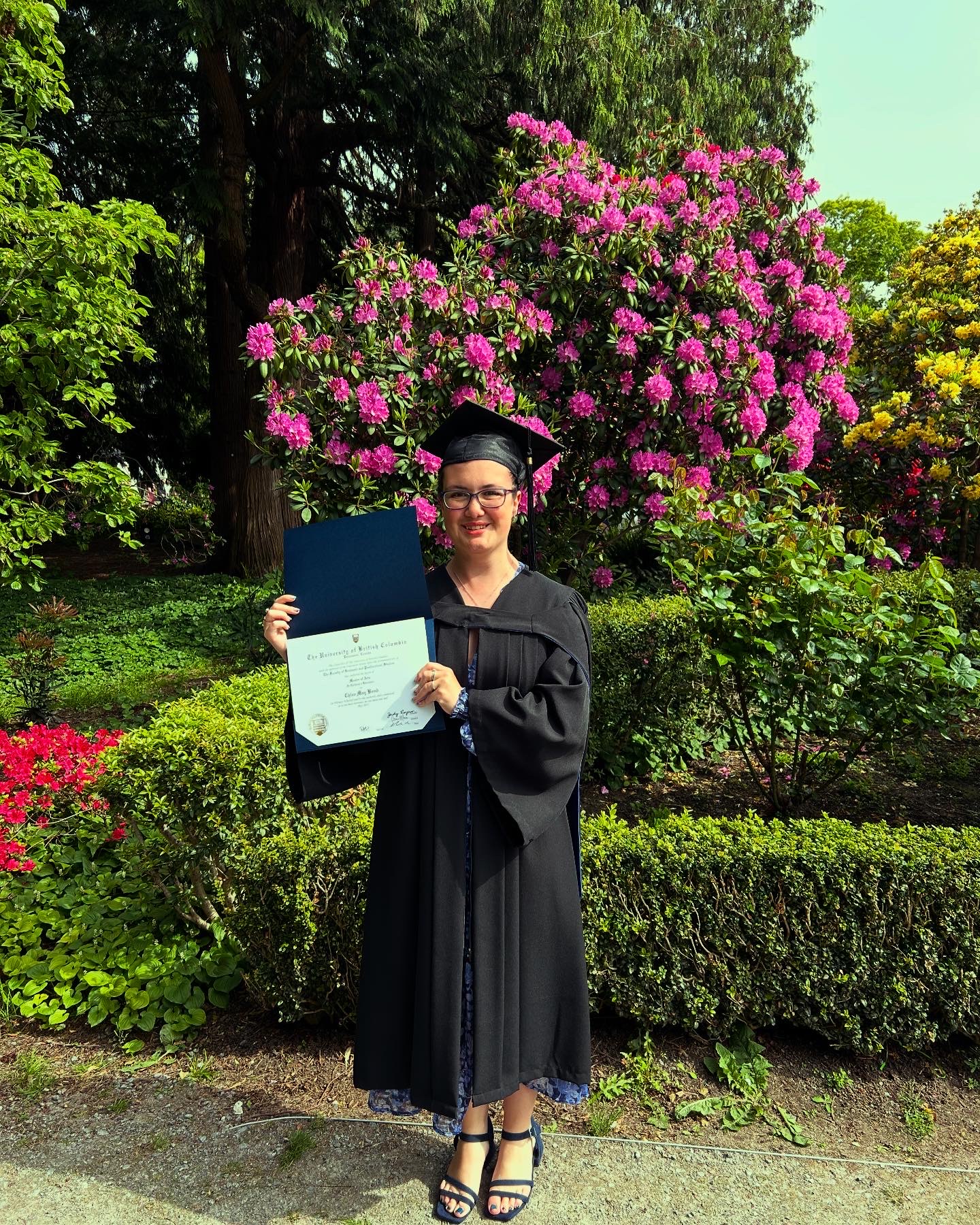 Chloe Bond UBC Graduation Chloe in graduation gown and holding her masters certificate